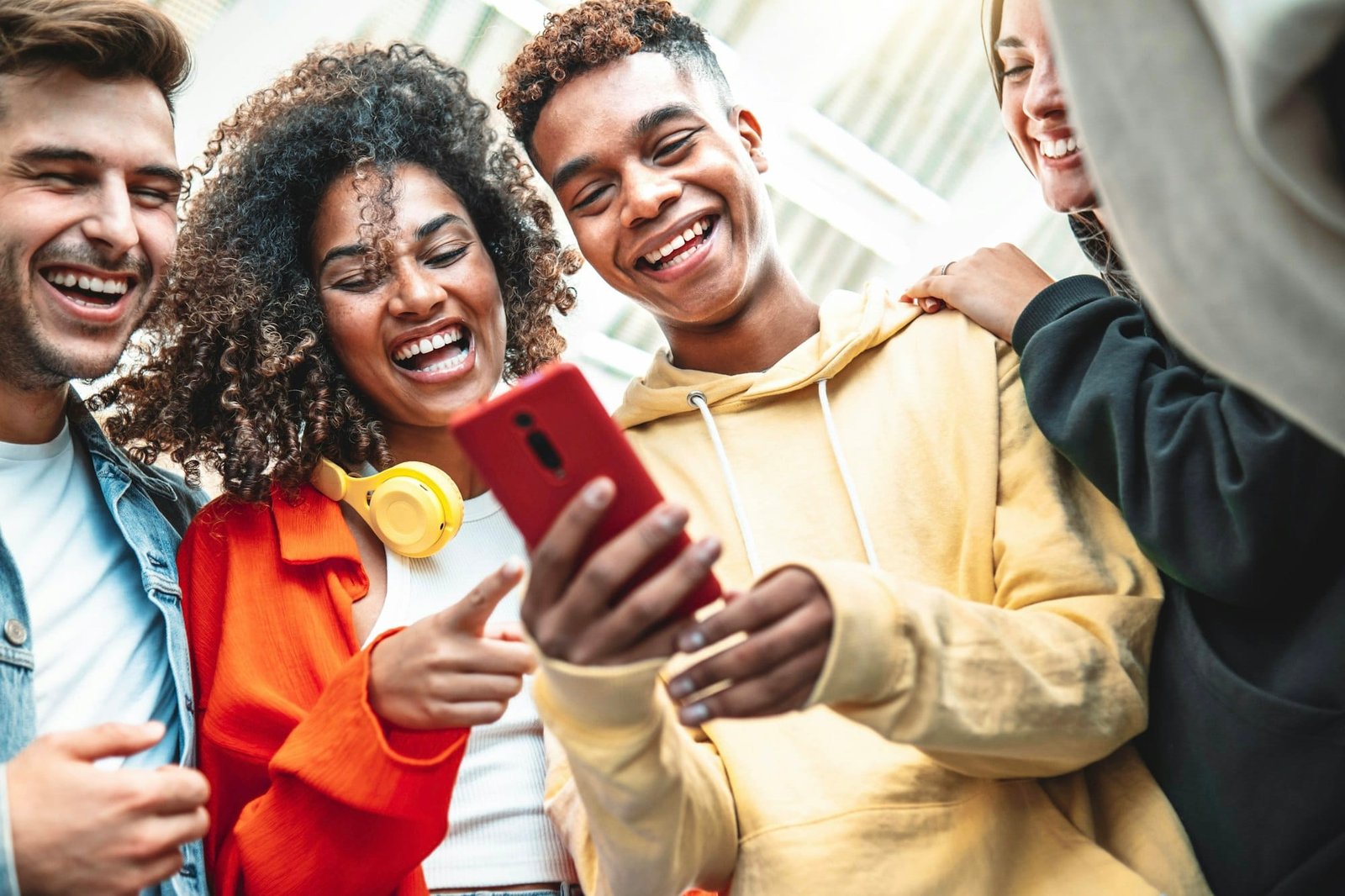 Young people using smart mobile phone device outdoors